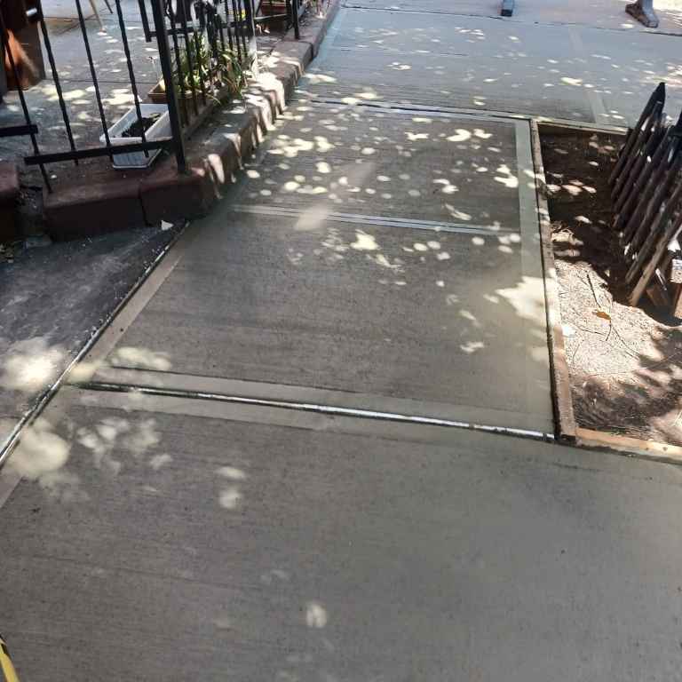 A finished concrete sidewalk poured to DOT specification